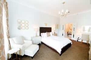 The cozy Petite Boerne room, featuring a plush Queen-sized bed with a delightful New Orleans-style balcony.