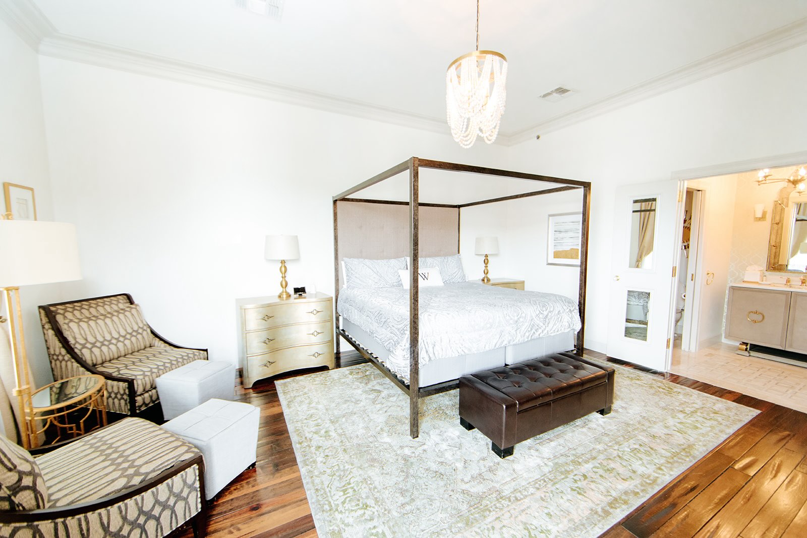 The Deluxe Room at The William, featuring a luxurious king-sized bed and cozy armchairs.